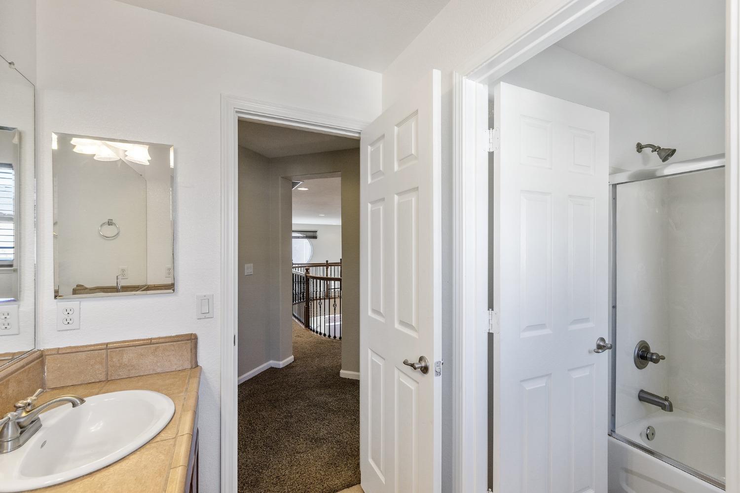 2090 Wisteria Place Manteca, CA 95337 - Photo 56 of 78 a bathroom with a granite countertop sink toilet and shower