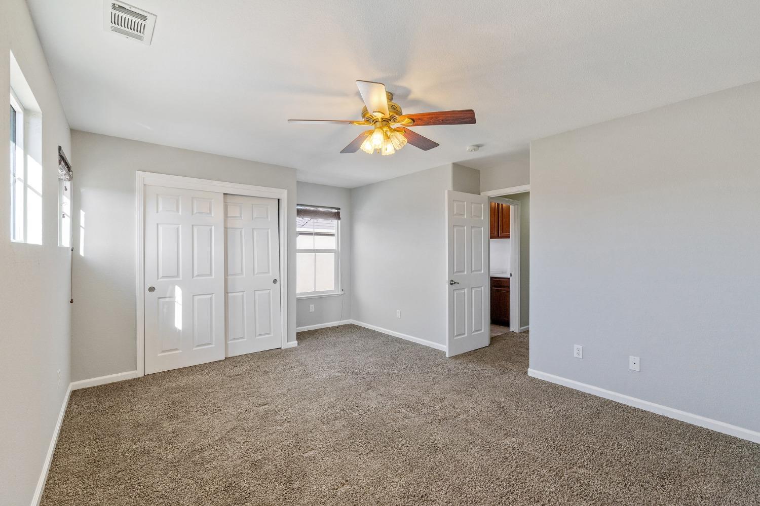 2090 Wisteria Place Manteca, CA 95337 - Photo 57 of 78 an empty room with closet and a chandelier fan