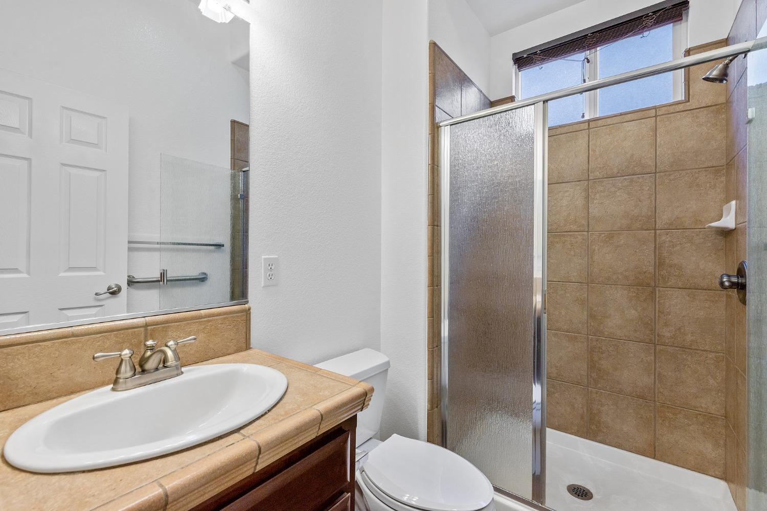 2090 Wisteria Place Manteca, CA 95337 - Photo 60 of 78 a bathroom with a sink toilet and shower