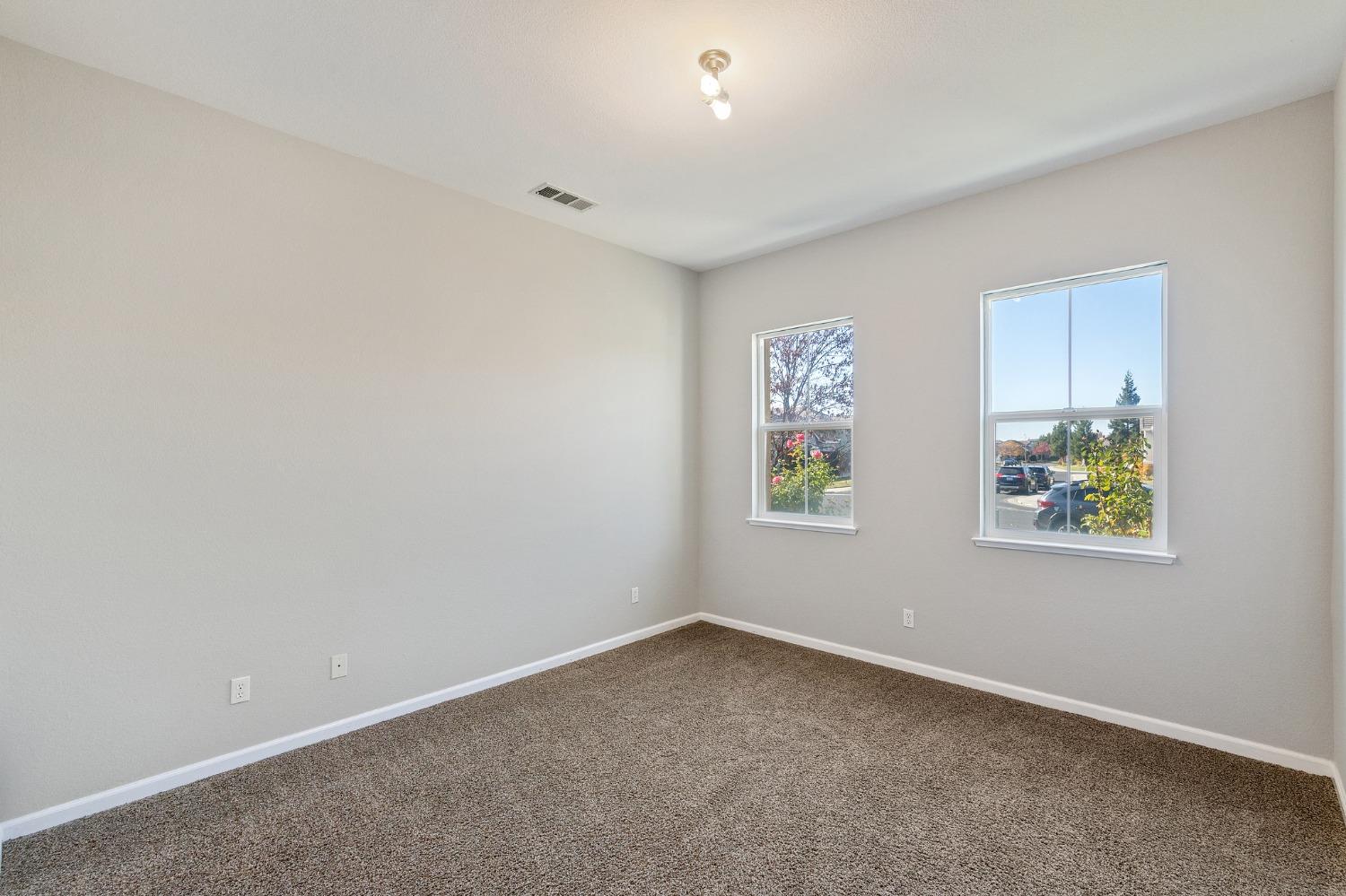 2090 Wisteria Place Manteca, CA 95337 - Photo 61 of 78 an empty room with painting on the wall and window
