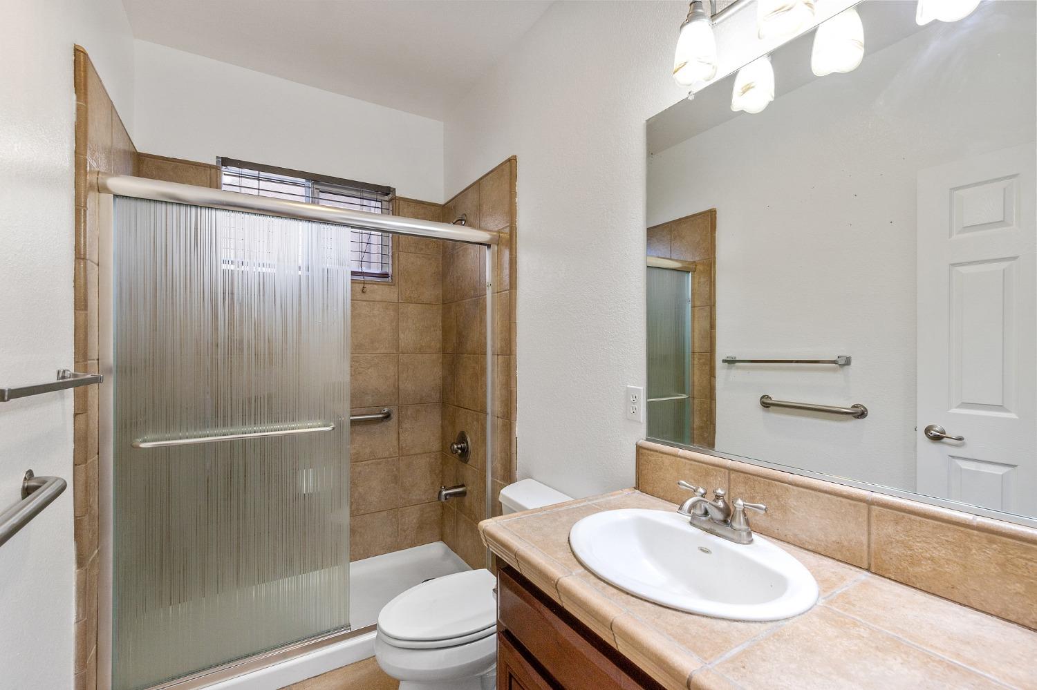 2090 Wisteria Place Manteca, CA 95337 - Photo 65 of 78 a bathroom with a sink toilet and shower