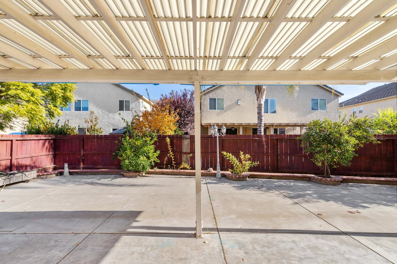 2090 Wisteria Place Manteca, CA 95337 - Photo 70 of 78 a view of a patio with table and chairs under an umbrella