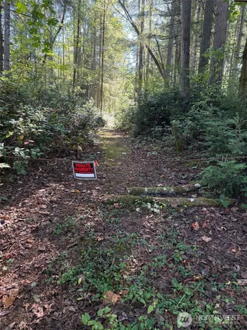 a red brick house with lots of trees