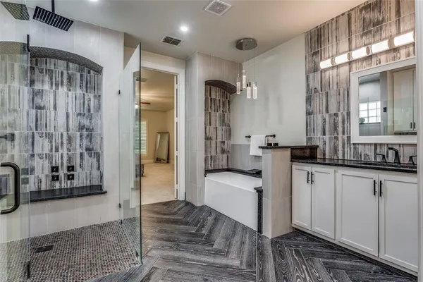 a large bathroom with a glass door shower