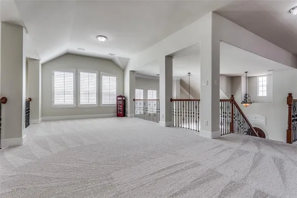 a view of a hallway with wooden floor and a livingroom
