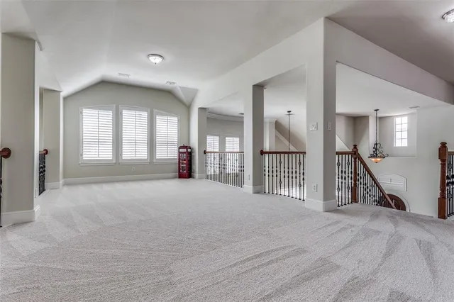 a view of a hallway with wooden floor and a livingroom