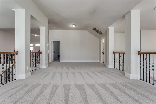 a view of a hallway with wooden floor and entryway