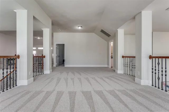 a view of a hallway with wooden floor and entryway