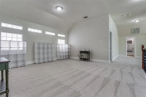 an empty room with windows and pillars in it