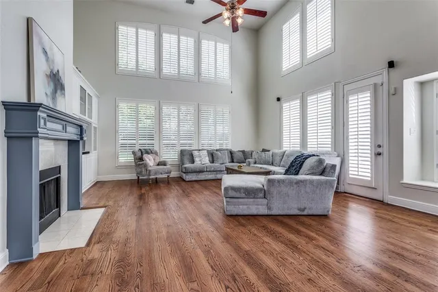 a living room with fireplace furniture and a wooden floor