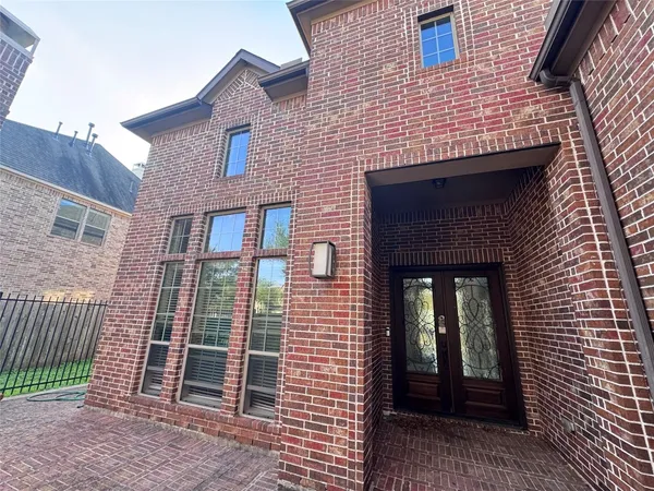 a brick house with a window and front door