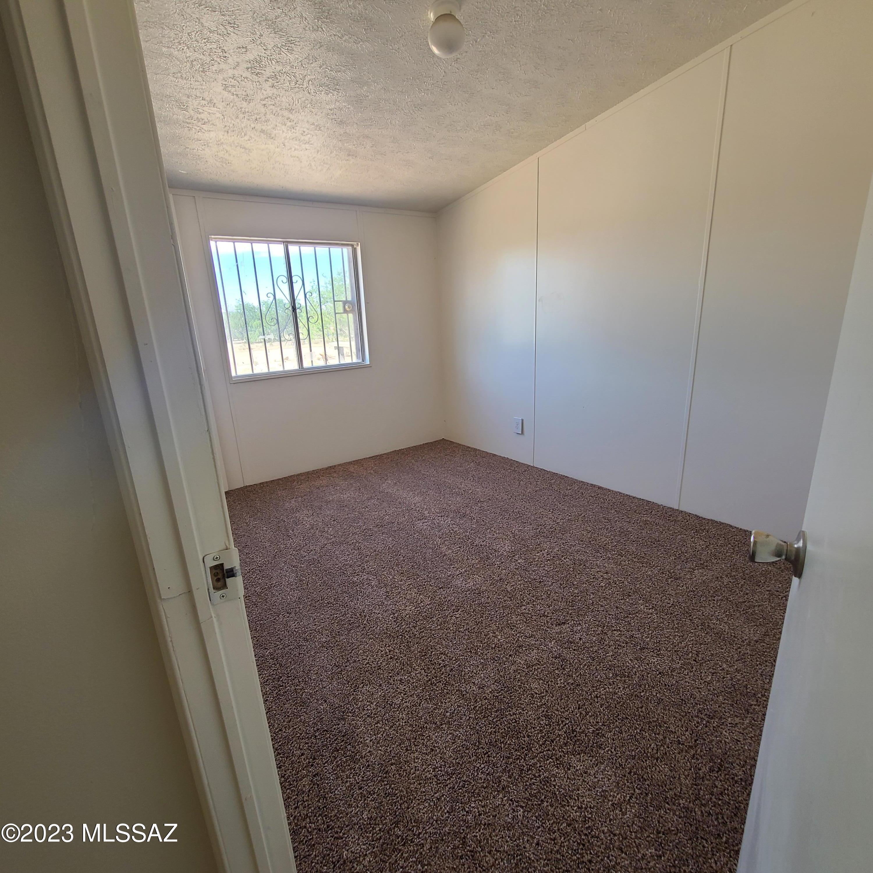 8896 South Marstellar Road Tucson, AZ 85736 - Photo 21 of 39 an empty room with windows