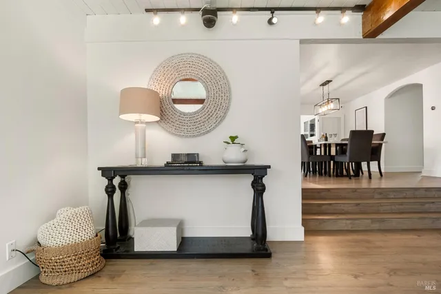 a bathroom with a sink a mirror and a potted plant