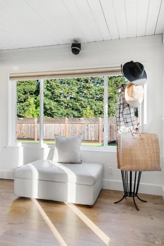 a kitchen with a sink dishwasher a stove a dining table and chairs with wooden floor