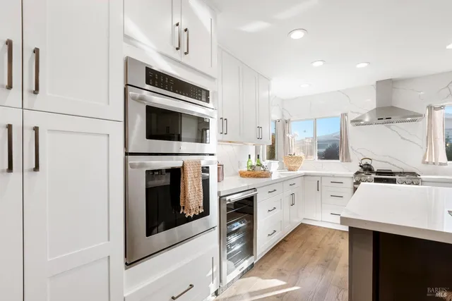 a bedroom with a bed next to a window and a flat screen tv