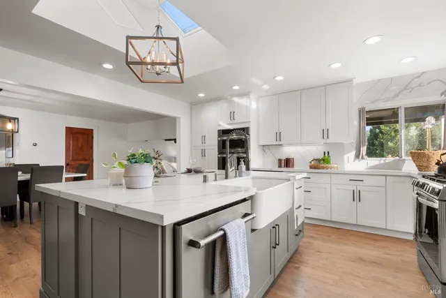a bathroom with a sink a toilet a large mirror and shower