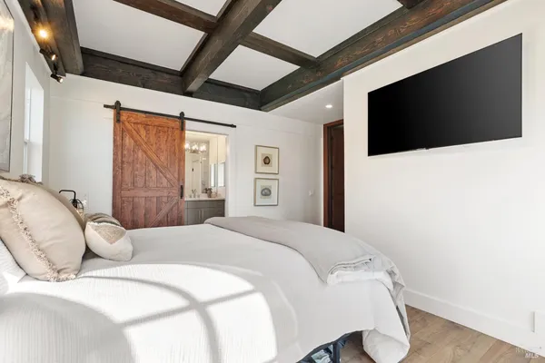 a bedroom with a large bed and a window