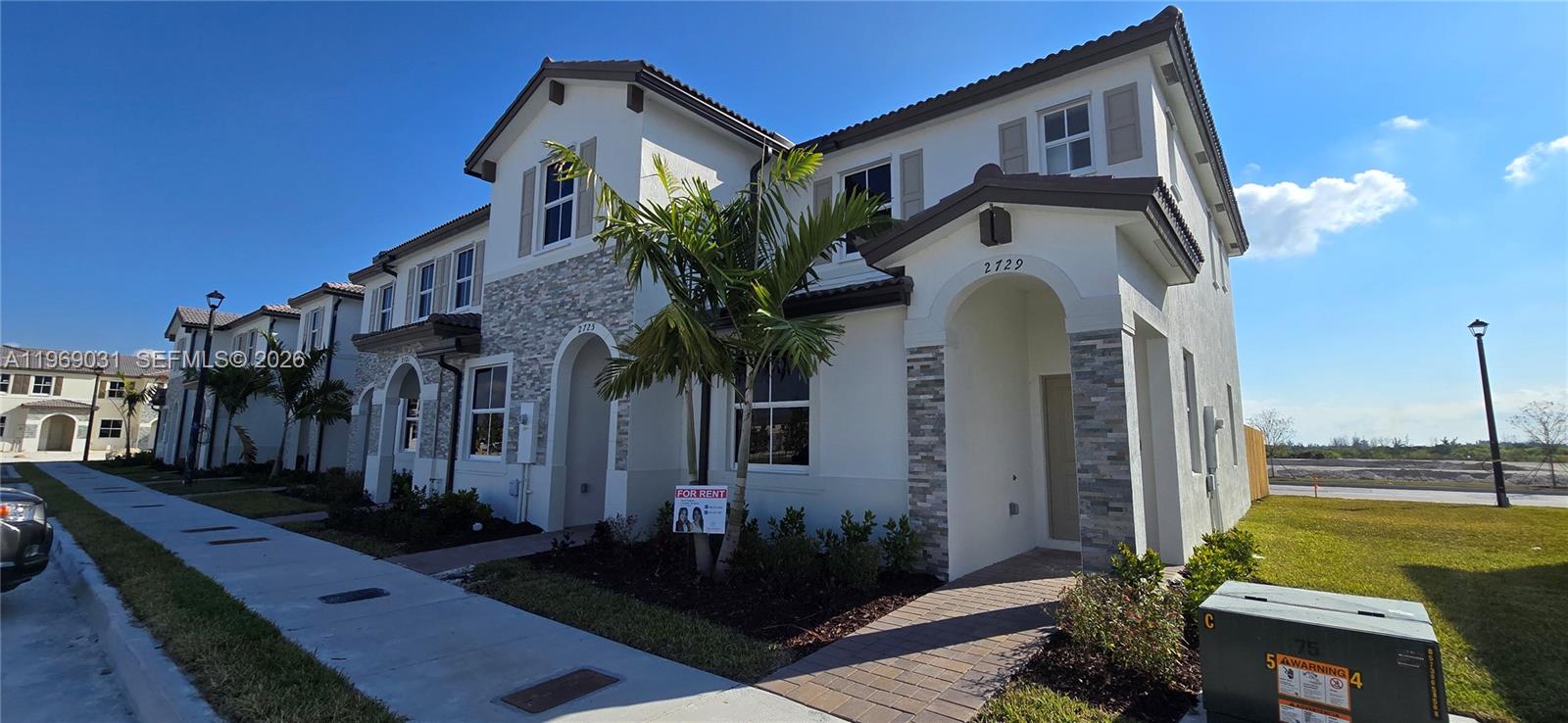 2729 Southeast 26th Road, Unit 2729 Homestead, FL 33035 - Photo 1 of 57 a front view of a house with garden