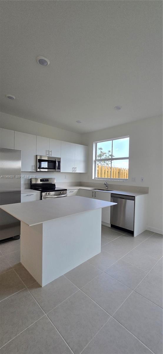 2729 Southeast 26th Road, Unit 2729 Homestead, FL 33035 - Photo 13 of 57 a living room with stainless steel appliances kitchen island granite countertop a sink and cabinets