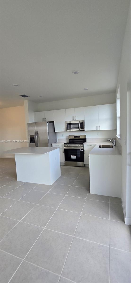 2729 Southeast 26th Road, Unit 2729 Homestead, FL 33035 - Photo 15 of 57 a kitchen with a cabinets and white appliances