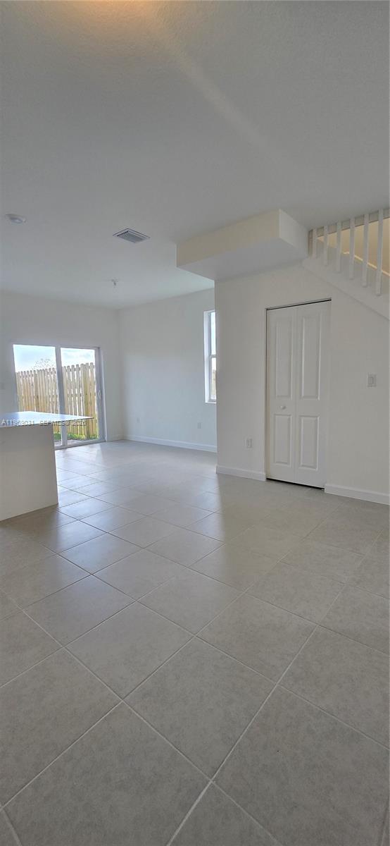 2729 Southeast 26th Road, Unit 2729 Homestead, FL 33035 - Photo 16 of 57 a view of an empty room with wooden floor and a window