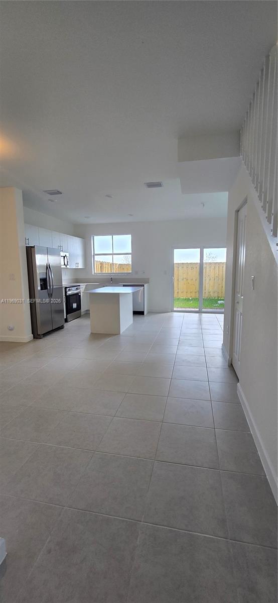 2729 Southeast 26th Road, Unit 2729 Homestead, FL 33035 - Photo 18 of 57 a view of a livingroom with kitchen and furniture