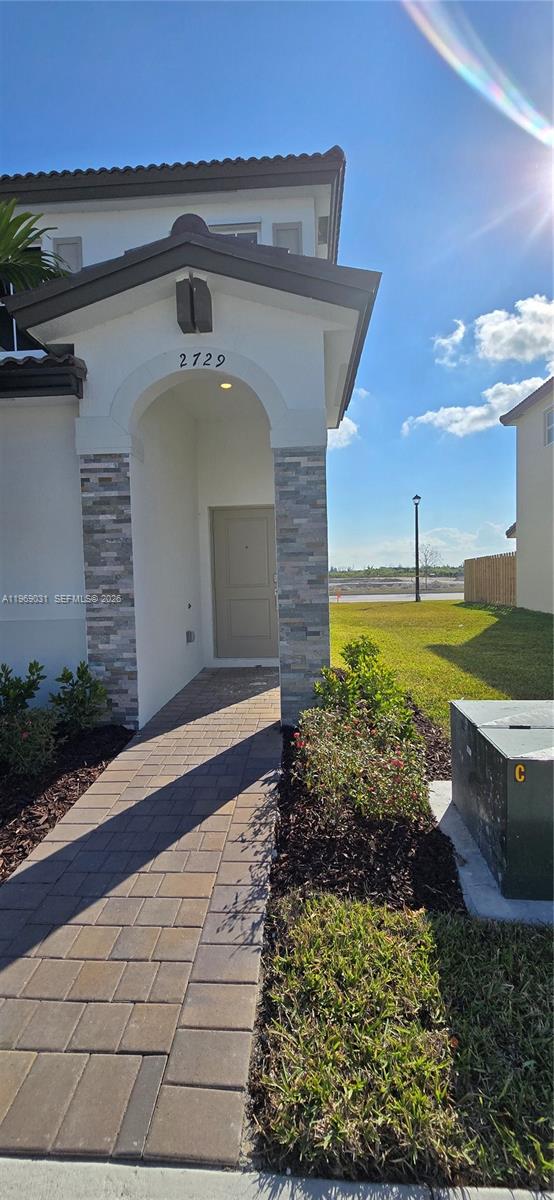 2729 Southeast 26th Road, Unit 2729 Homestead, FL 33035 - Photo 2 of 57 a front view of a house with a yard