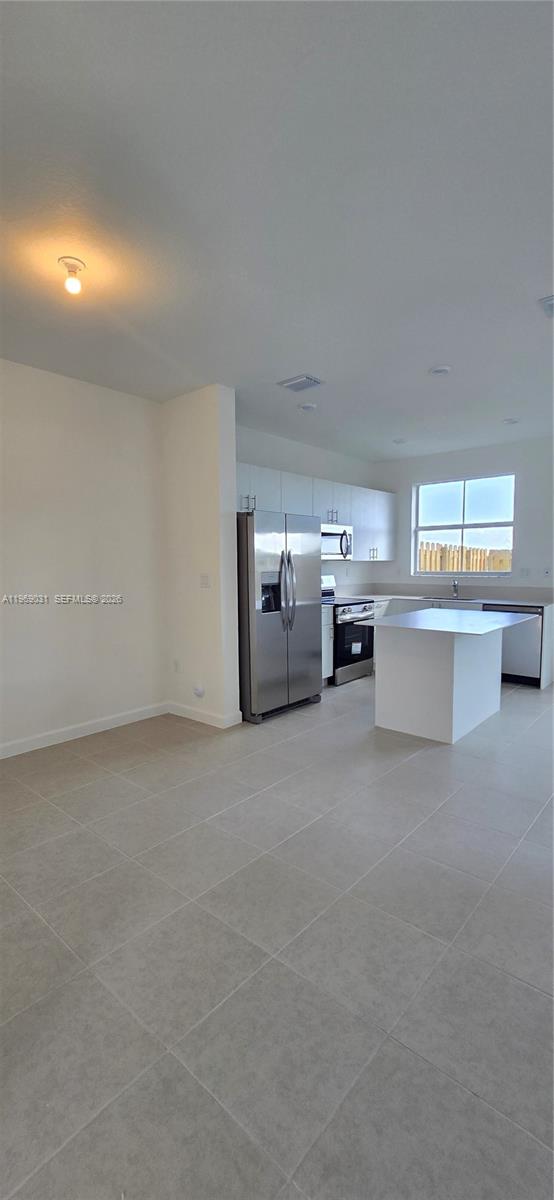 2729 Southeast 26th Road, Unit 2729 Homestead, FL 33035 - Photo 30 of 57 a big room with chandelier and windows