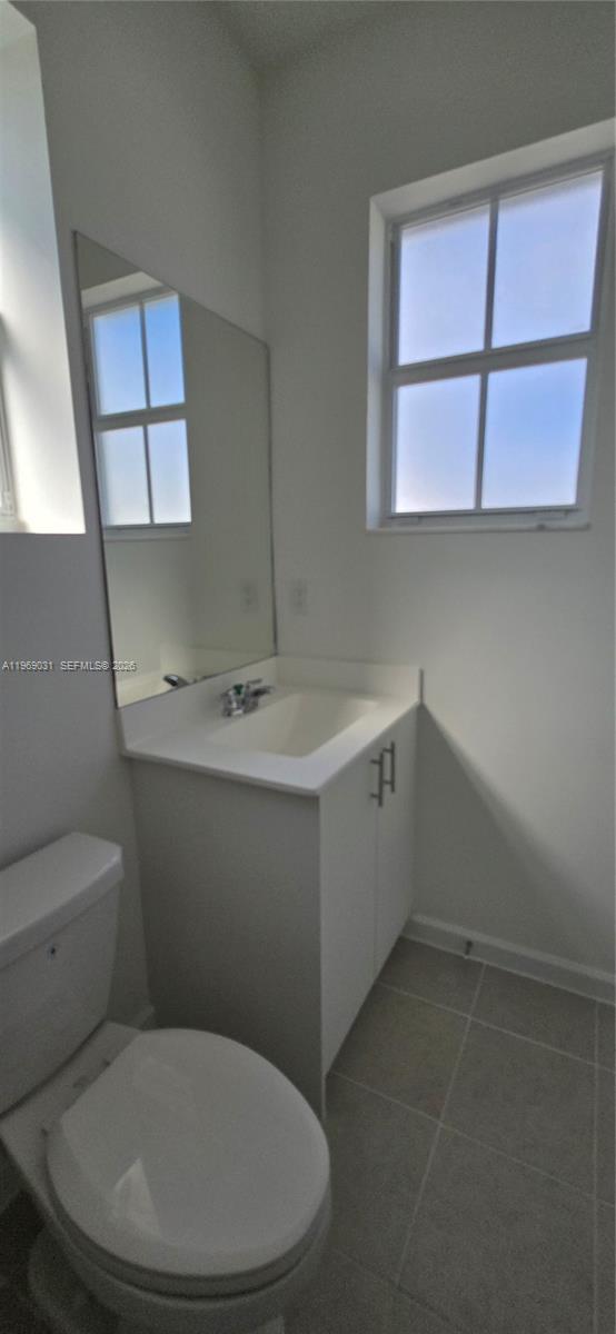 2729 Southeast 26th Road, Unit 2729 Homestead, FL 33035 - Photo 39 of 57 a white toilet sitting next to a bathroom sink