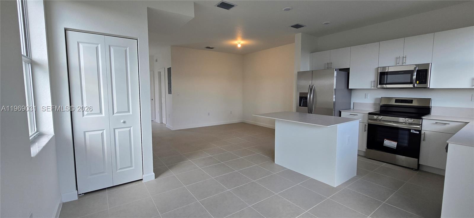 2729 Southeast 26th Road, Unit 2729 Homestead, FL 33035 - Photo 47 of 57 a kitchen with cabinets and stainless steel appliances