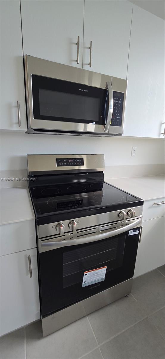 2729 Southeast 26th Road, Unit 2729 Homestead, FL 33035 - Photo 49 of 57 a stove top oven sitting inside of a kitchen