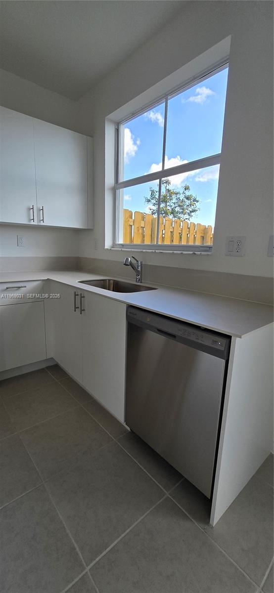 2729 Southeast 26th Road, Unit 2729 Homestead, FL 33035 - Photo 51 of 57 a kitchen with a sink window and cabinets