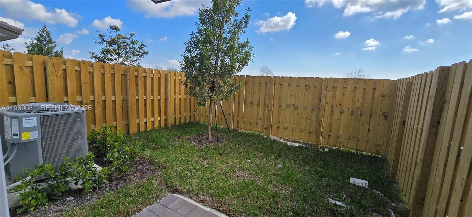 2729 Southeast 26th Road, Unit 2729 Homestead, FL 33035 - Photo 54 of 57 a view of backyard with potted plants and wooden fence