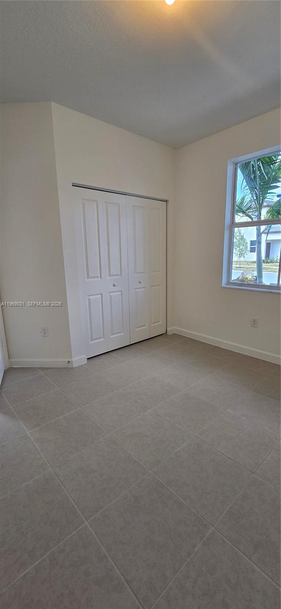 2729 Southeast 26th Road, Unit 2729 Homestead, FL 33035 - Photo 7 of 57 a view of an empty room with a window