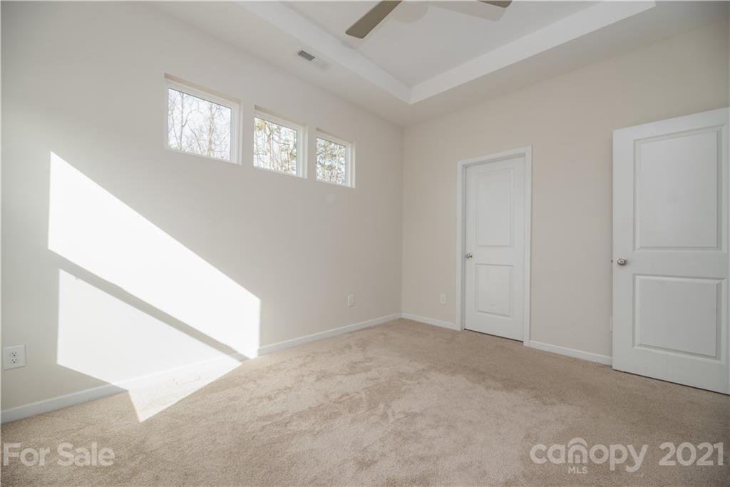5027 Elizabeth Road Charlotte, NC 28269 - Photo 11 of 23 an empty room with windows and closet