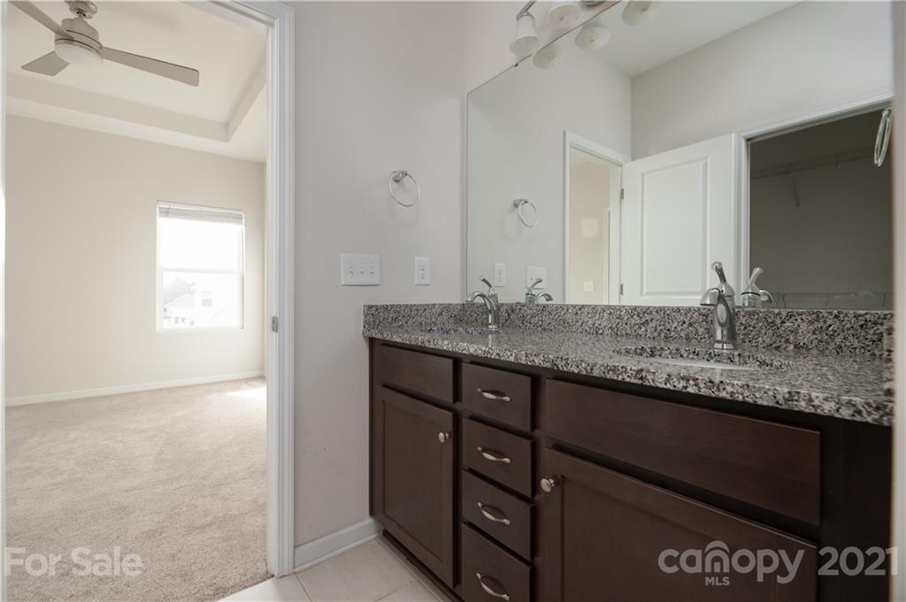 5027 Elizabeth Road Charlotte, NC 28269 - Photo 15 of 23 a bathroom with a granite countertop sink and a mirror