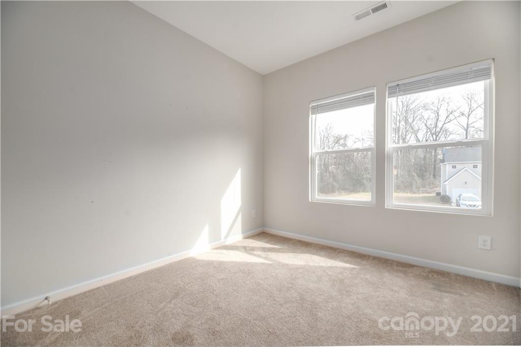 5027 Elizabeth Road Charlotte, NC 28269 - Photo 16 of 23 an empty room with windows