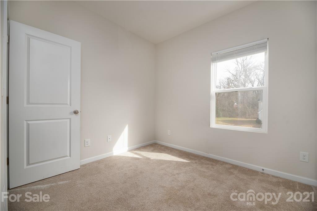 5027 Elizabeth Road Charlotte, NC 28269 - Photo 20 of 23 an empty room with a window