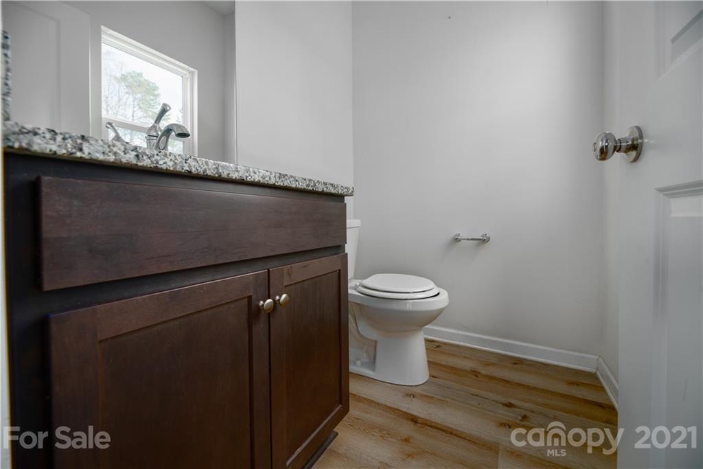 5027 Elizabeth Road Charlotte, NC 28269 - Photo 9 of 23 a bathroom with a granite countertop sink and a toilet