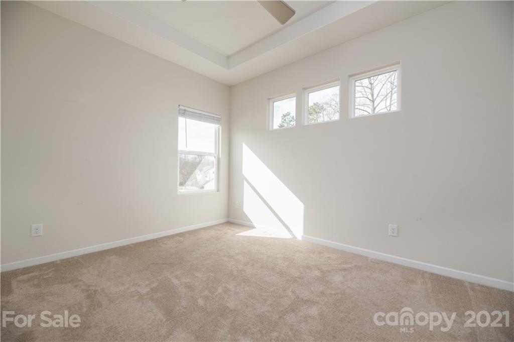 5027 Elizabeth Road Charlotte, NC 28269 - Photo 10 of 23 an empty room with windows