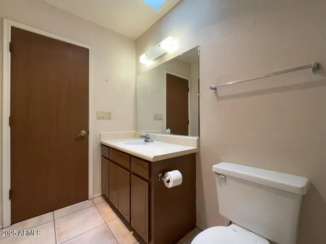 a bathroom with a sink a toilet a mirror and vanity