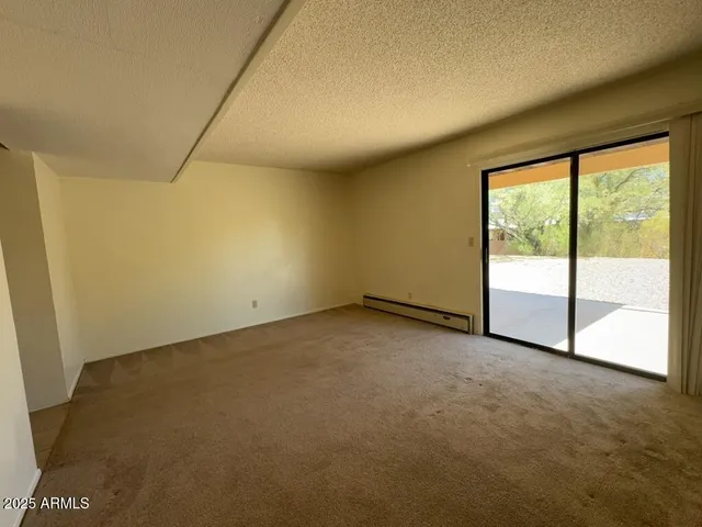 an empty room with sliding glass door