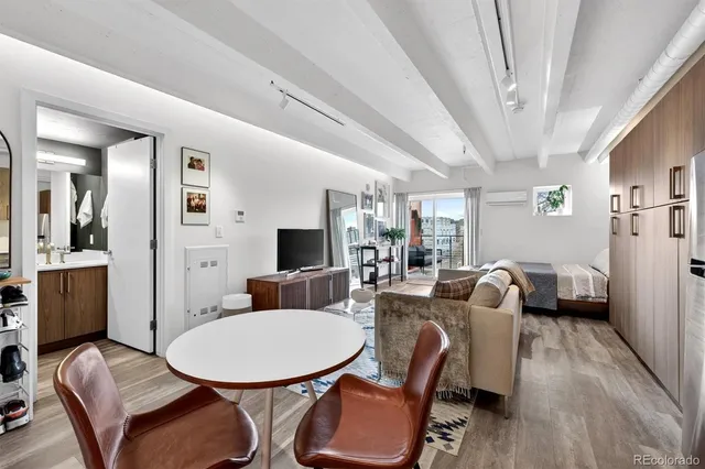 a living room with furniture and a floor to ceiling window