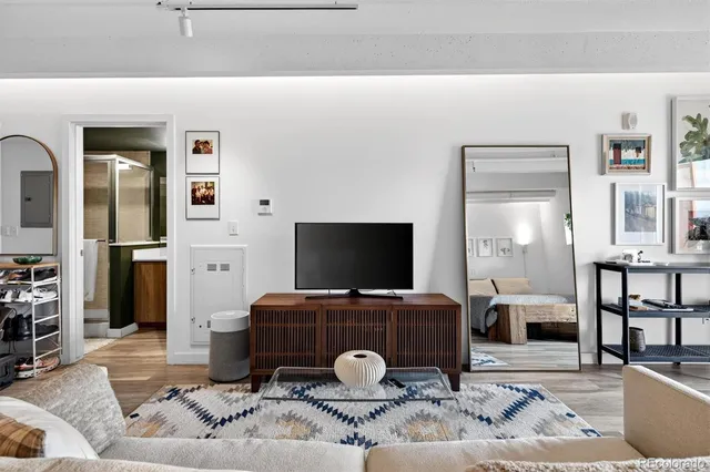 a bedroom with furniture and a wooden floor