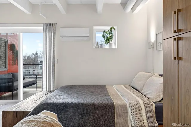 a bedroom with a bed and a wall painting