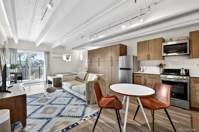 a living room with furniture a wooden floor and a chandelier