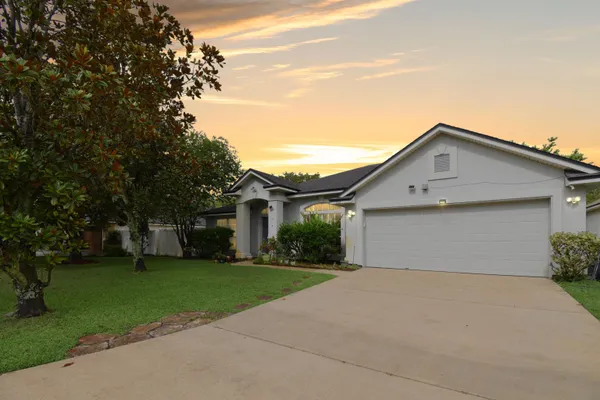 a front view of house with yard and green space