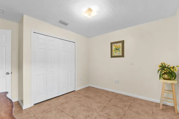 an empty room with a painting on the wall