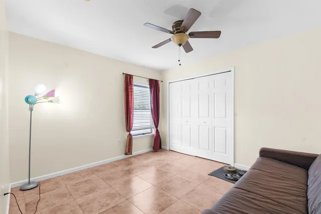a view of a livingroom with a ceiling fan and window