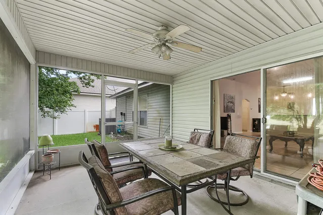a backyard of a house with a table and chairs